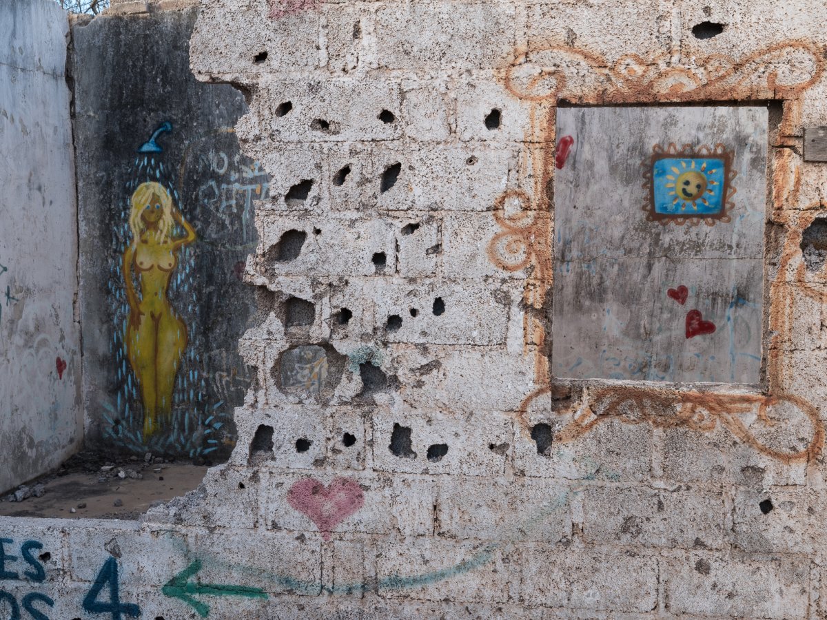 An old wall with murals.