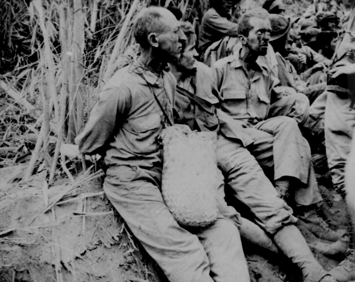 Captured soldiers along the march with their hands tied behind their backs