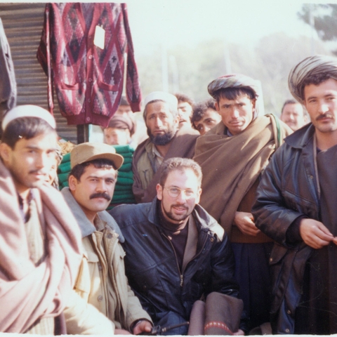 The author (crouching, middle) with a military commandant (crouching to his right, mustache and billed hat) in Mazar-i Sharif, 1996 The author (crouching, middle) with a military commandant (crouching to his right, mustache and billed hat) in Mazar-i Sharif, 1996