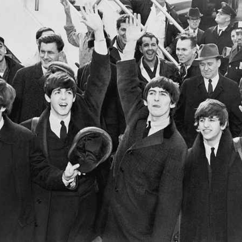 The Beatles arrive in 1964 to meet their new fans in America.