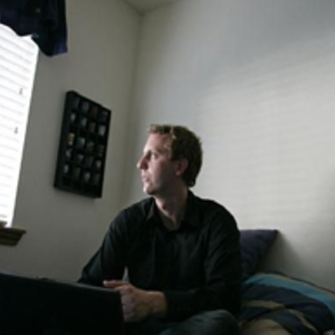 man looking out a window